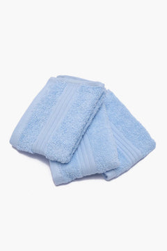 Set of soft, light blue cotton towels folded on a white background