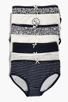 Set of seven women’s cotton briefs in navy, white, floral and striped patterns, neatly stacked.