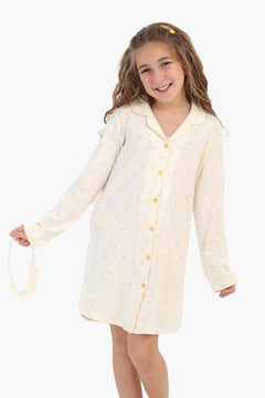 Girl wearing soft cotton nightshirt with yellow heart print, long sleeves, and matching headband