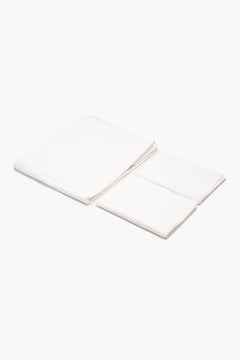 Folded white cotton fabric pieces on a plain background, soft textile set