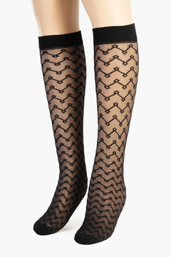Black sheer knee-high socks with geometric zigzag pattern on mannequin legs