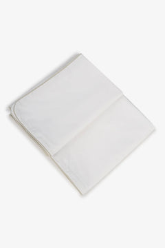 Folded white cotton fabric on a plain background