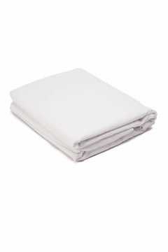 Folded white cotton bedsheet on white background, soft bedding textile