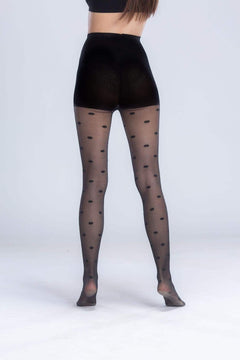 Woman wearing sheer black pantyhose with large polka dot pattern, back view