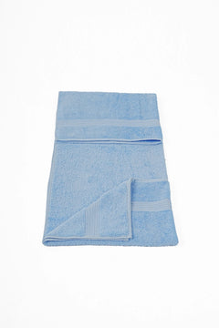 Soft light blue cotton towel with textured borders, folded on a white background