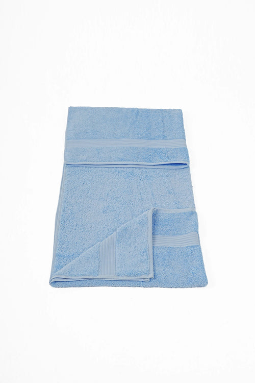 Soft light blue cotton towel with textured borders, folded on a white background