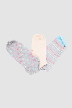 Three pairs of cotton ankle socks in pastel polka dot, solid, and striped designs on a plain background.
