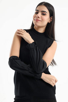 Woman wearing sleeveless black knit top with detachable black elastic sleeves