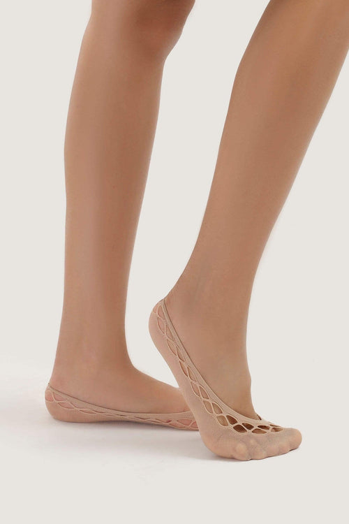 Women's feet wearing nude mesh invisible socks with crisscross pattern, on light background