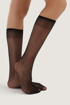 Sheer black knee-high stretch socks on model legs, women's hosiery for everyday wear